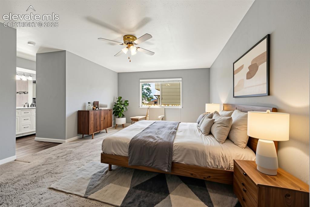 Image 15 of 49: Spacious bedroom with a ceiling fan, a window providing natural light, and 