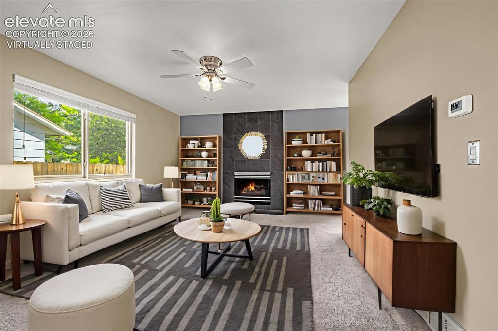 Image 2 of 49: Bright living area featuring a vaulted ceiling and a ceiling fan Virtually 