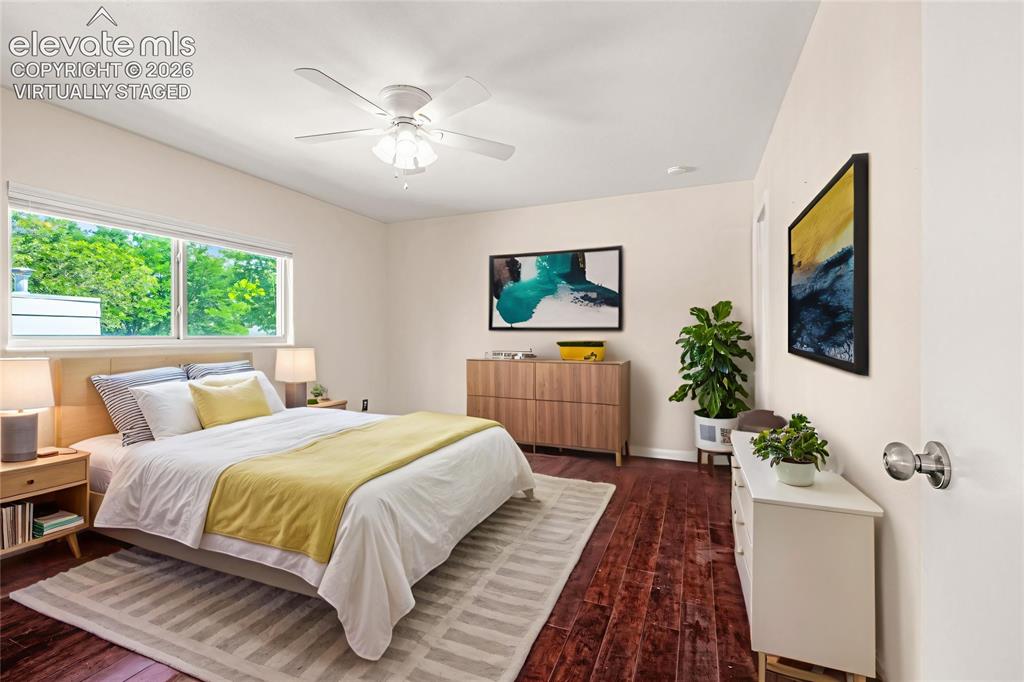 Image 24 of 49: Bedroom featuring wood-finish flooring, light-toned walls, and a ceiling fa