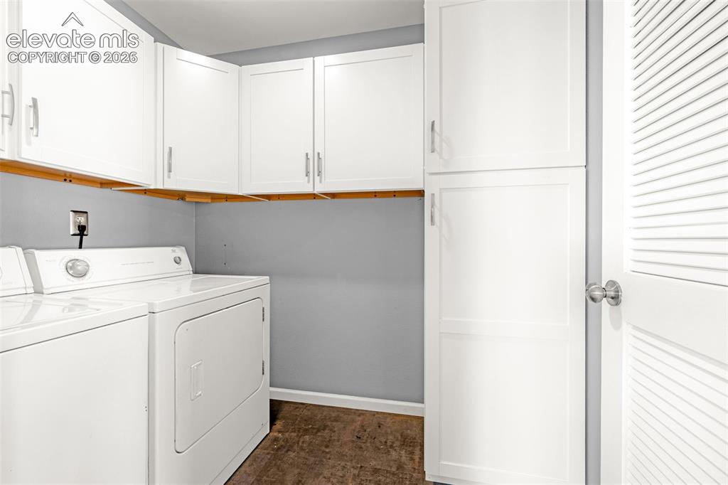 Image 28 of 49: Laundry area featuring white shaker-style cabinetry, wood-finish flooring, 