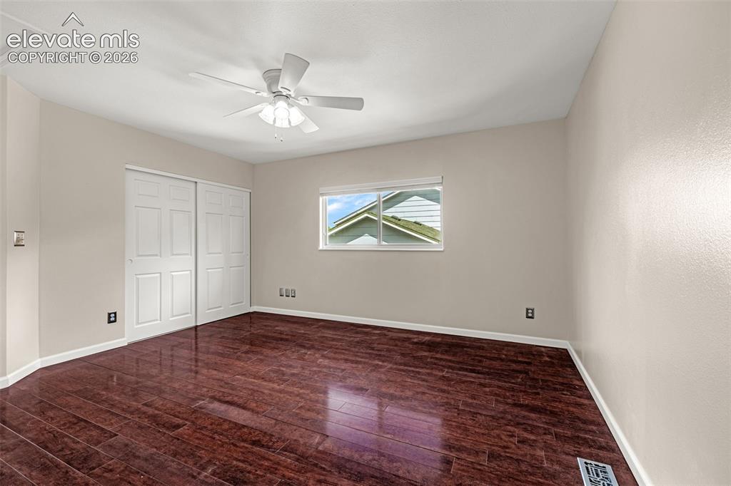 Image 46 of 49: Room featuring rich wood-finish flooring, light neutral-toned walls, and a 
