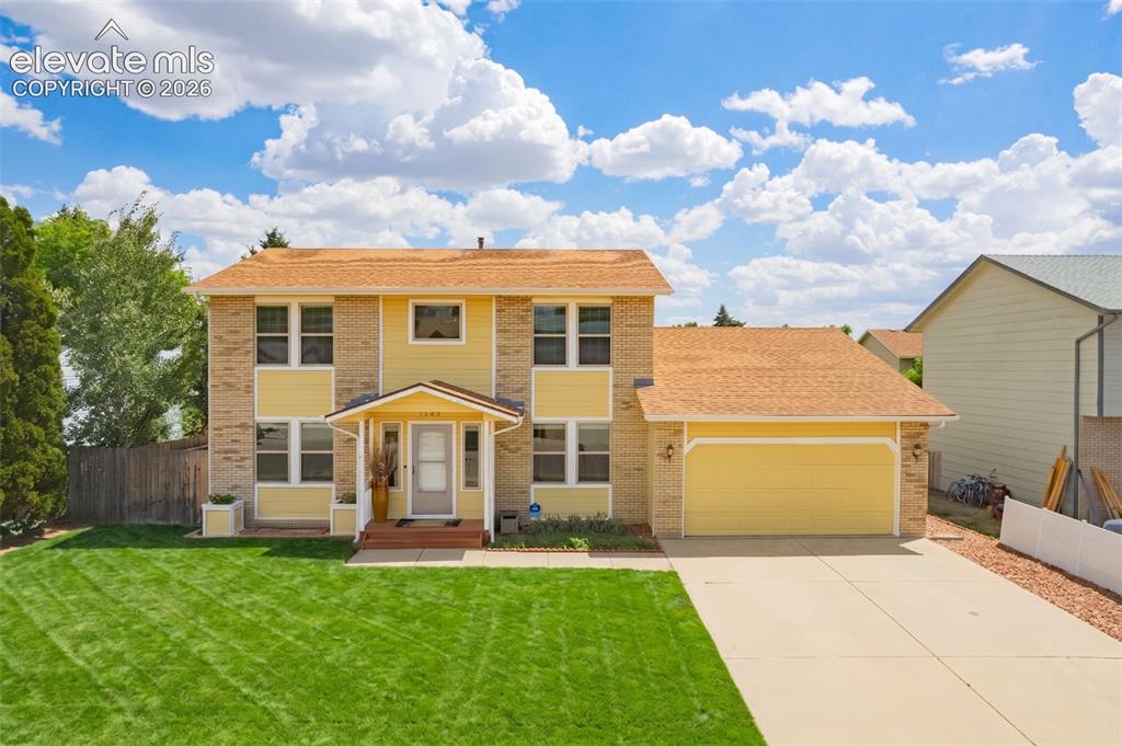 Image 49 of 49: Two-story residence featuring a brick and siding exterior, an attached two-