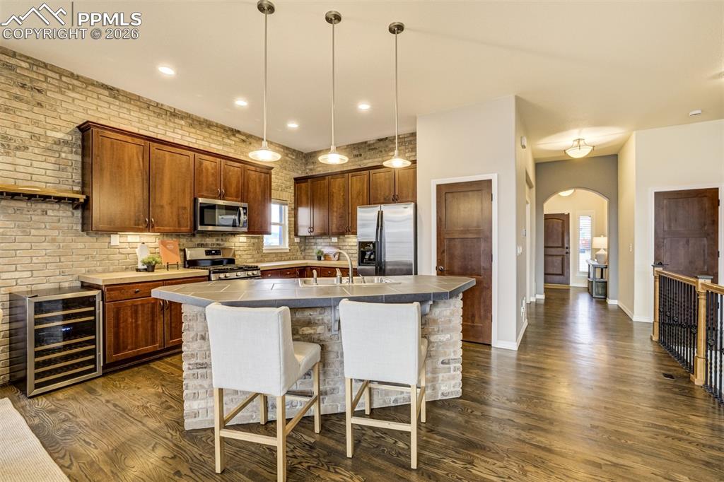Image 14 of 50: Lovely light fixtures adorn the kitchen