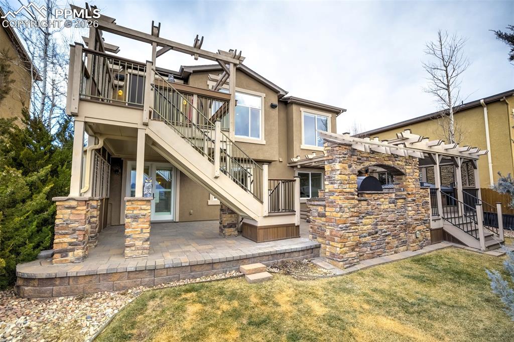 Image 47 of 50: Back yard with covered patio and deck