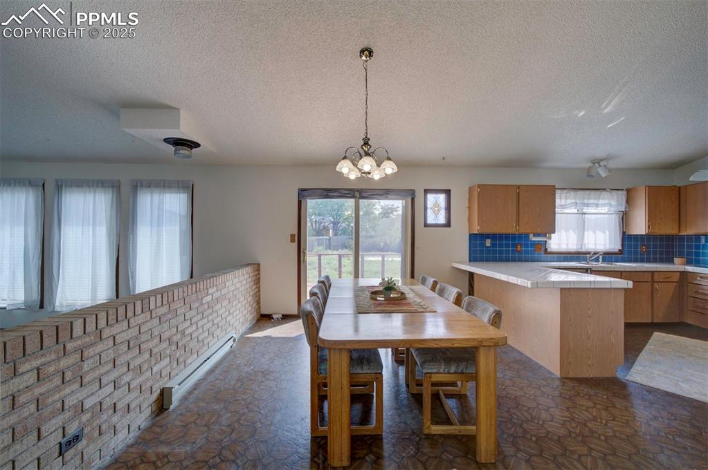 Image 12 of 50: The Dining Area with breakfast bar is conveniently located off the Kitchen 