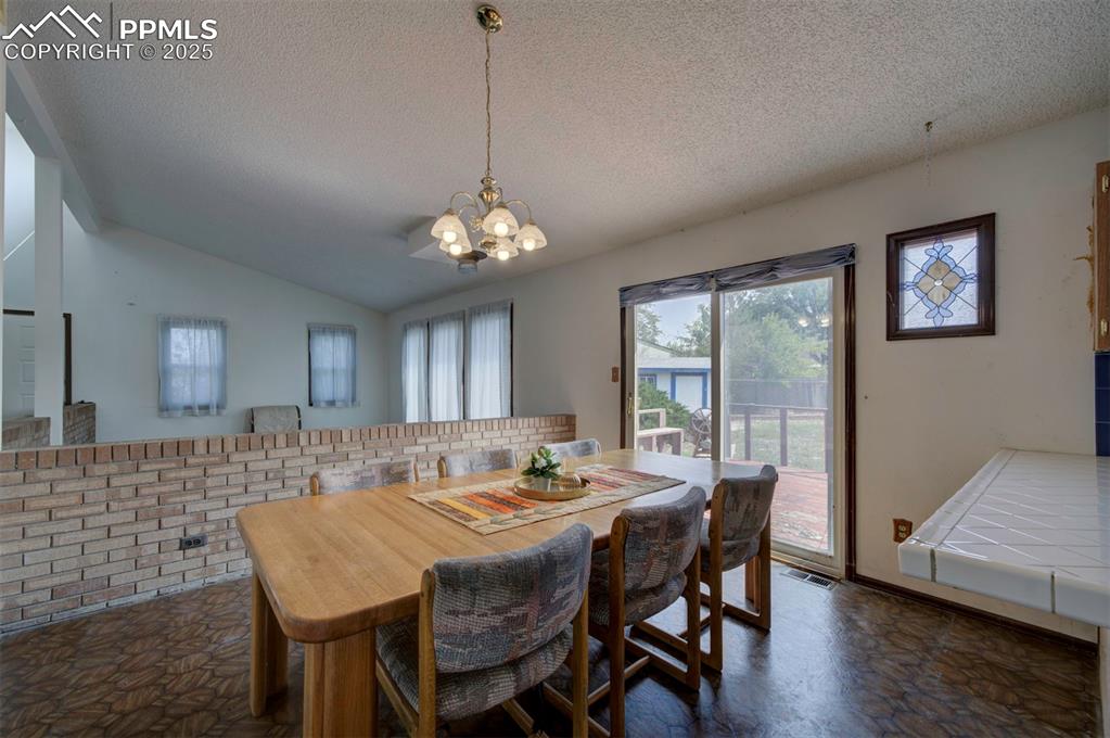 Image 13 of 50: Dining Area and Living Room.