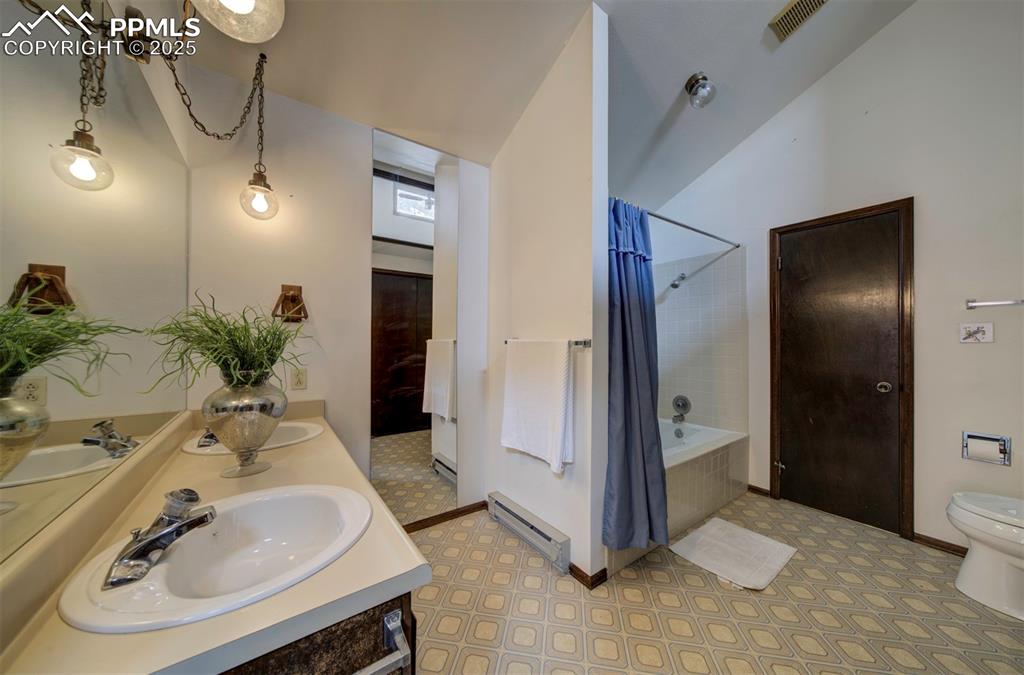 Image 26 of 50: Main level Primary Bathroom with vanity, mirror, and tub/shower.