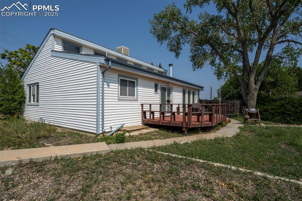 Image 39 of 50: Concrete walk way to backyard deck, great for outdoor fun and entertaining.