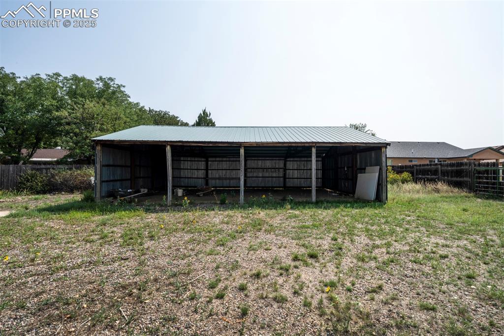 Image 42 of 50: Pole barn for storing small boat or camper.