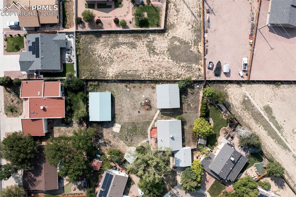 Image 48 of 50: Aerial rear view of home, 3-car detached garage, and adjacent 0.44-acre vac