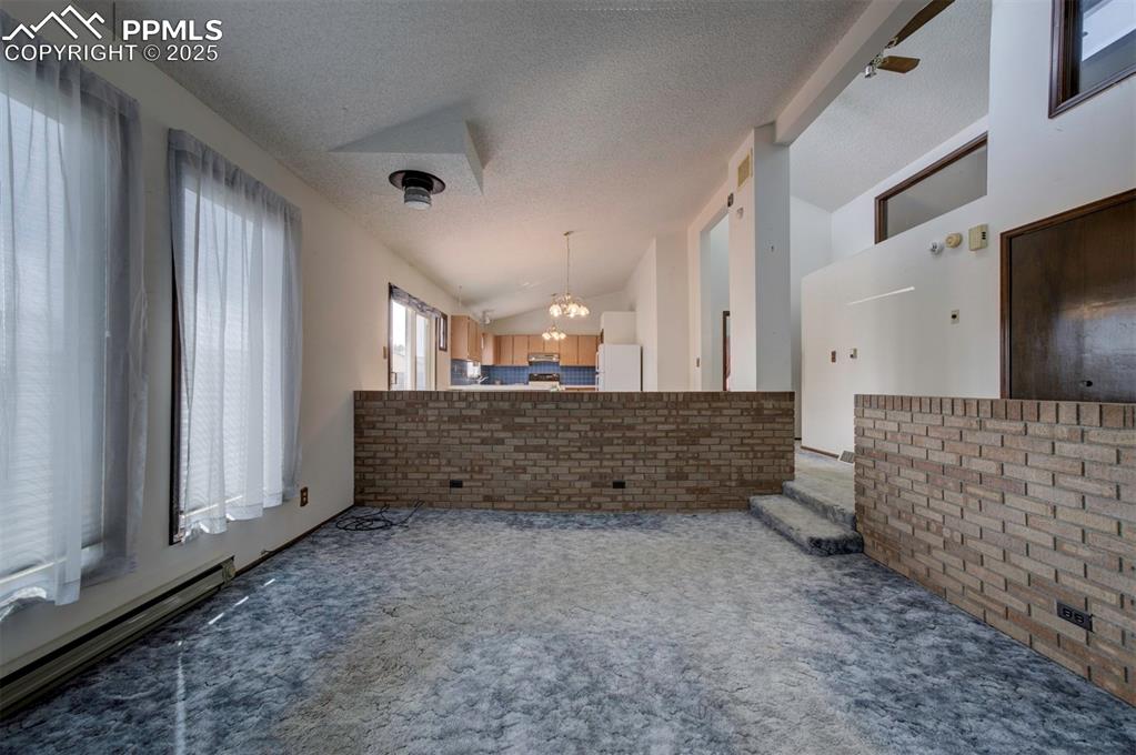 Image 6 of 50: Attractive brick surround in Living Room.