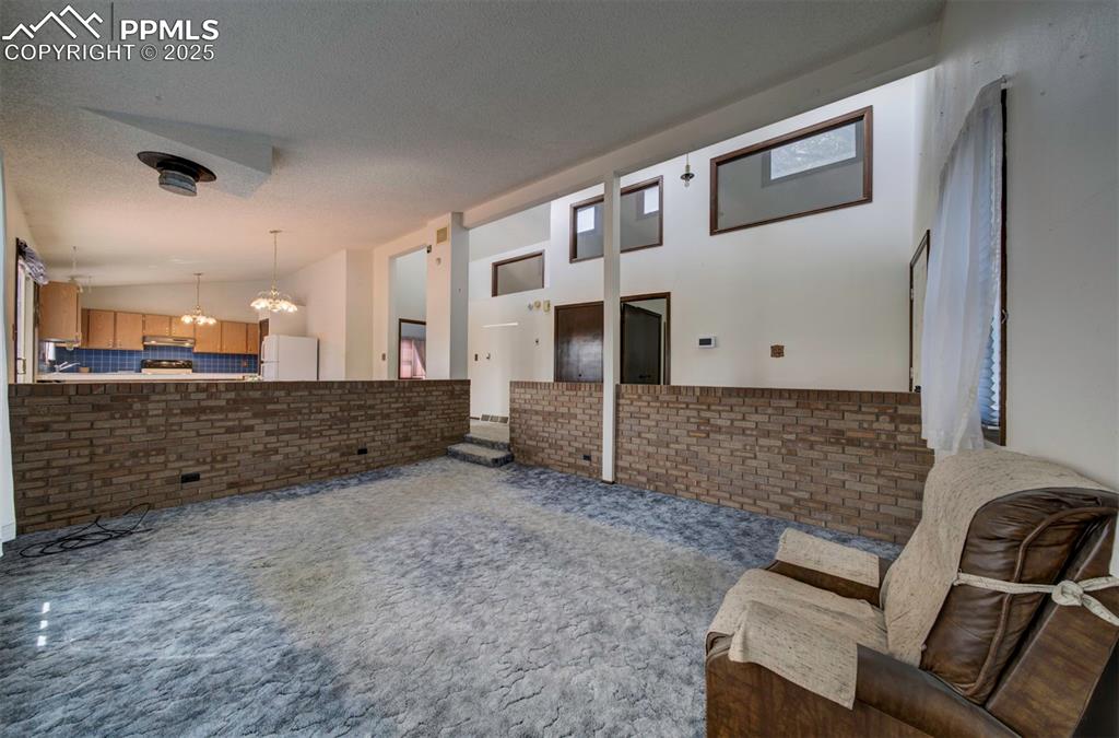 Image 9 of 50: Living Room with brick surround.