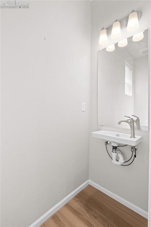 Image 10 of 26: Bathroom with baseboards and wood finished floors