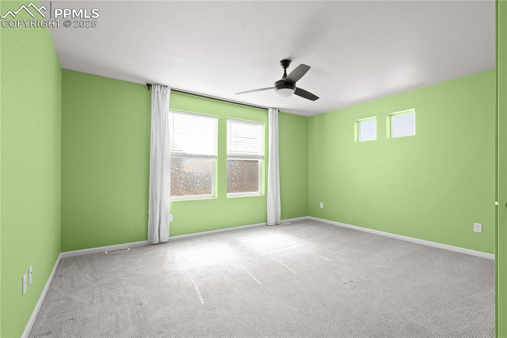 Image 12 of 26: Unfurnished room with baseboards, ceiling fan, and carpet flooring