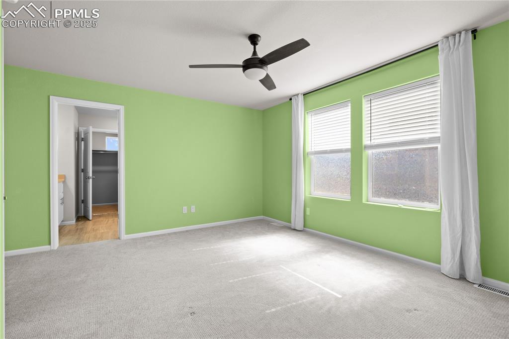 Image 13 of 26: Unfurnished bedroom featuring baseboards, ceiling fan, carpet flooring, and