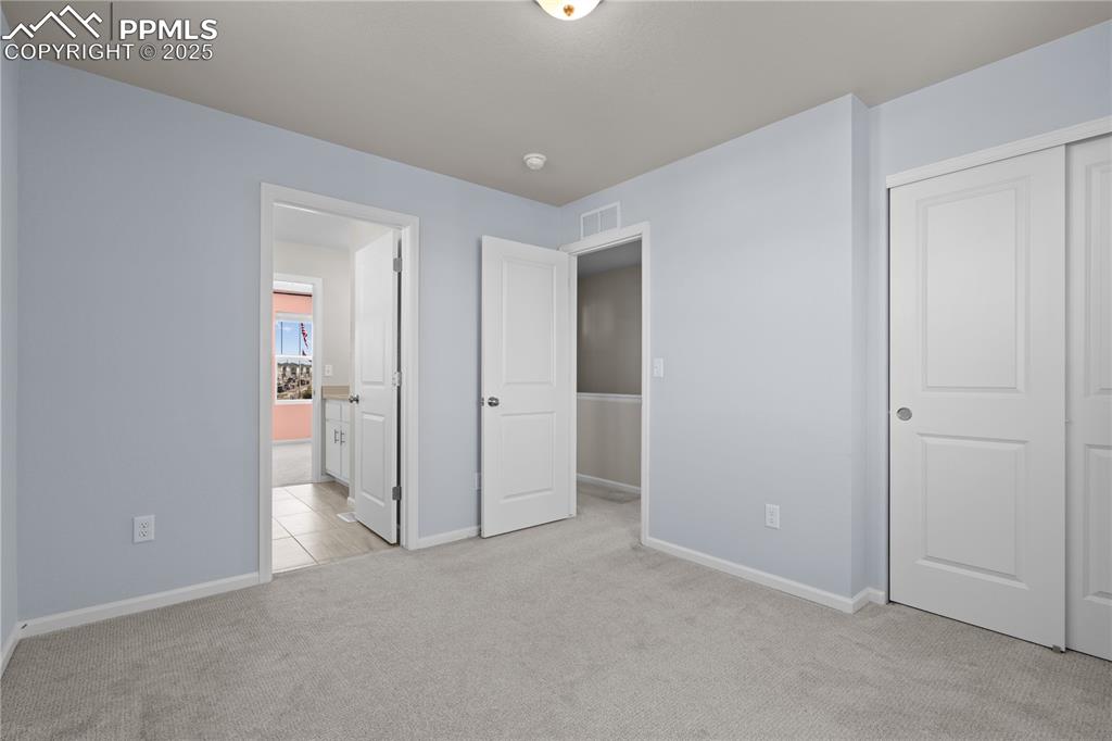 Image 20 of 26: Unfurnished bedroom featuring visible vents, a closet, baseboards, light co