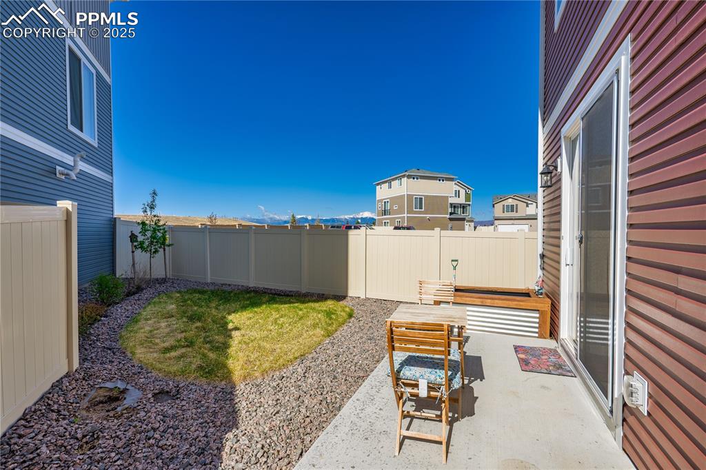 Image 25 of 26: View of yard featuring a fenced backyard and a patio area