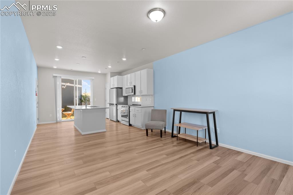 Image 7 of 26: Living room with recessed lighting, baseboards, and light wood-type floorin
