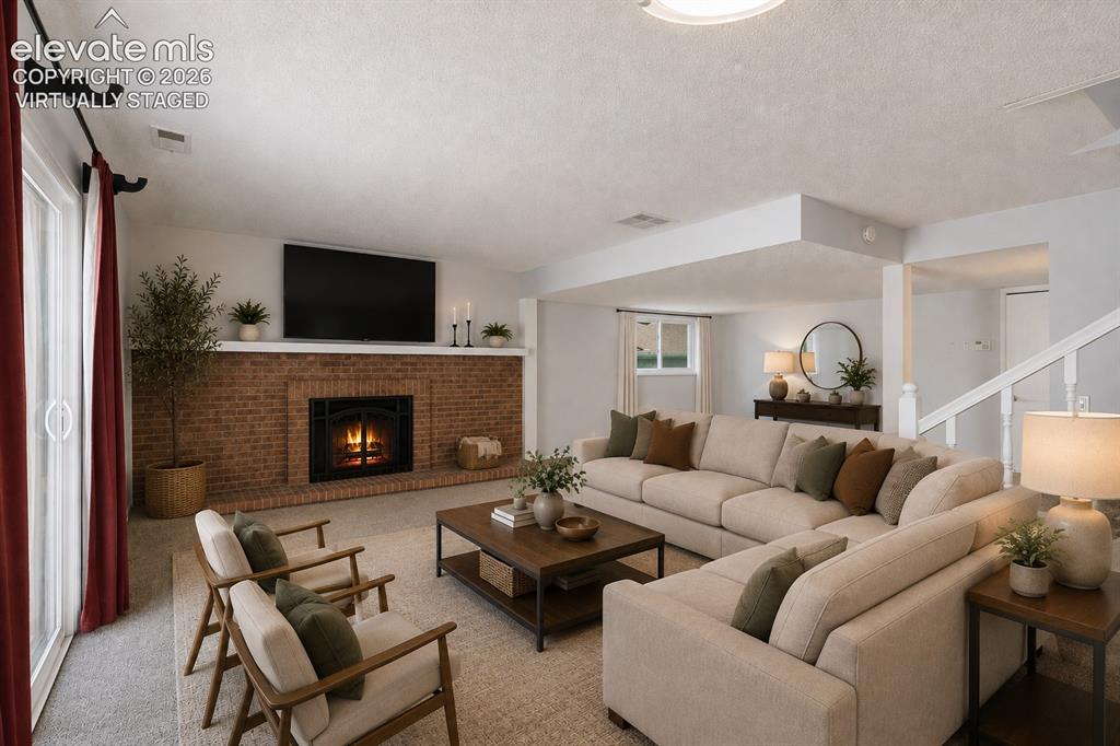 Image 17 of 32: Family-room with wood-burning fireplace. virtually staged