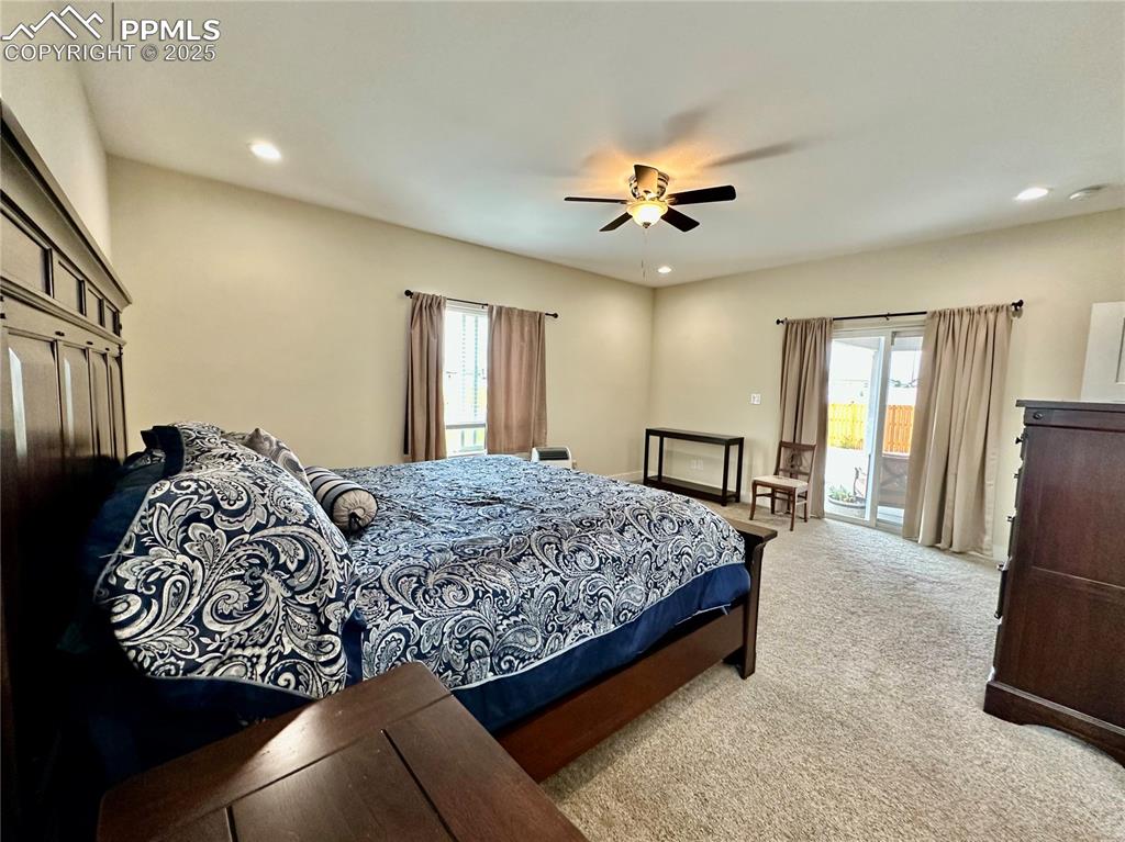 Image 15 of 38: Carpeted bedroom with access to exterior, recessed lighting, and a ceiling