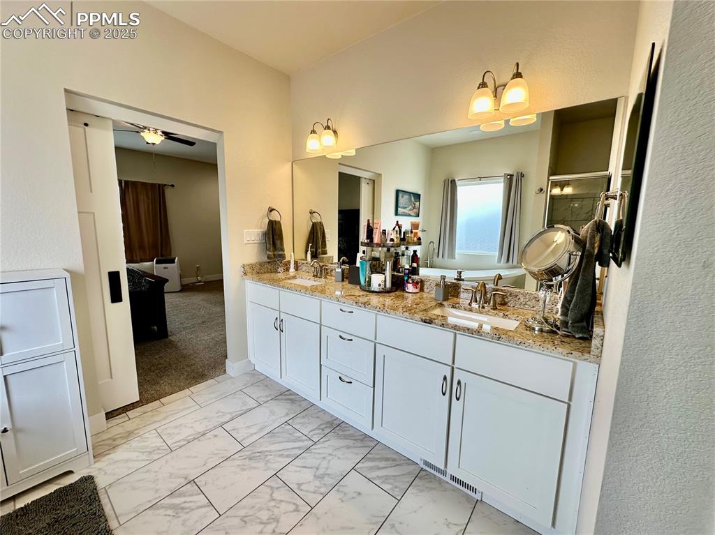 Image 19 of 38: Full bathroom featuring a sink and light marble finish floors