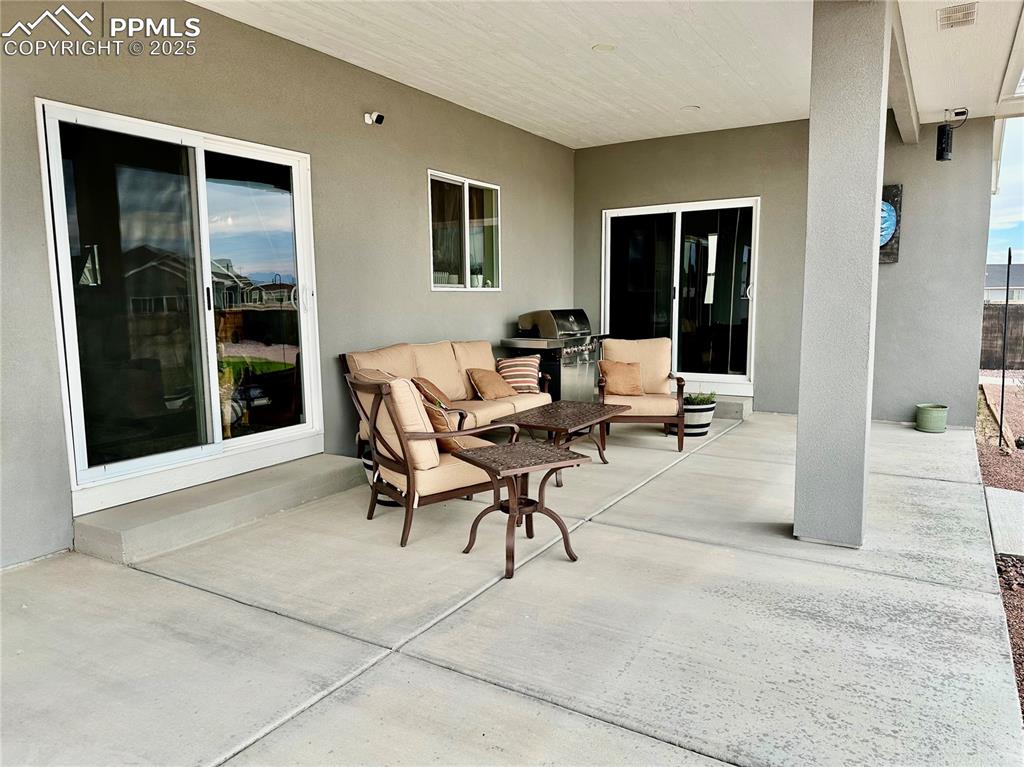 Image 29 of 38: View of patio / terrace featuring a grill and an outdoor living space