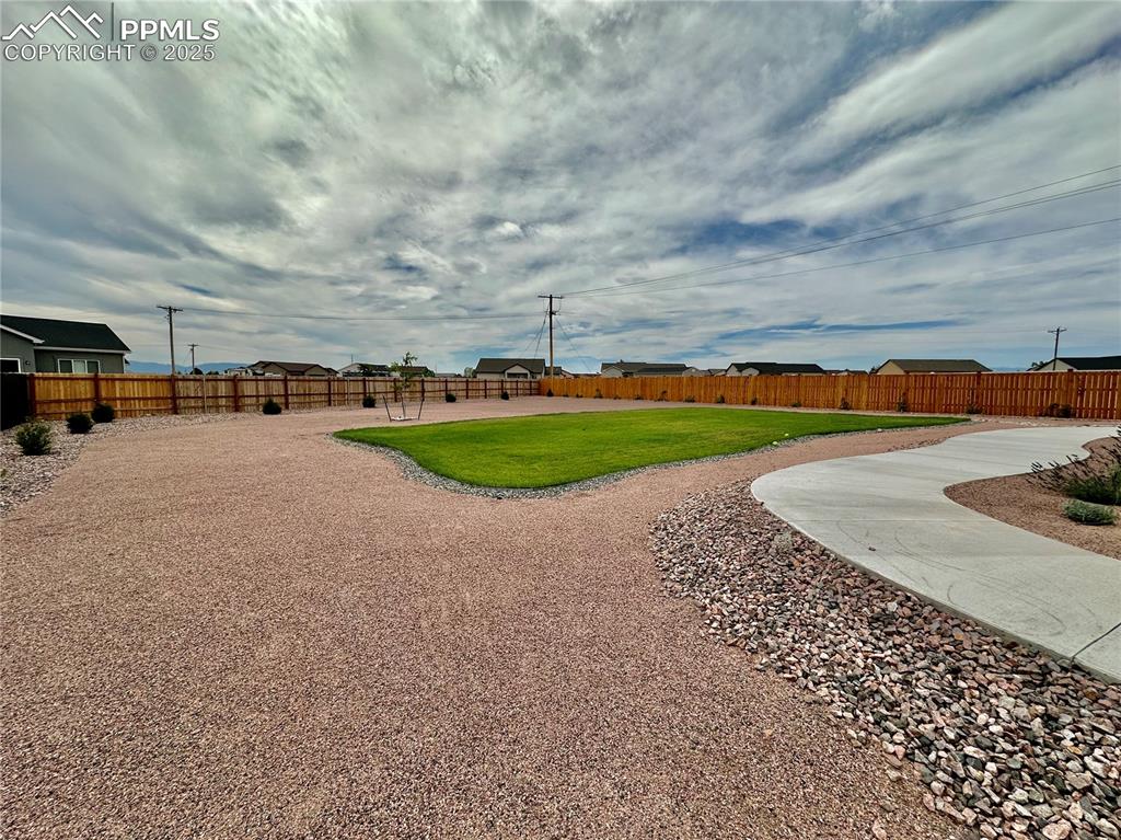Image 34 of 38: Surrounding community with a fenced backyard