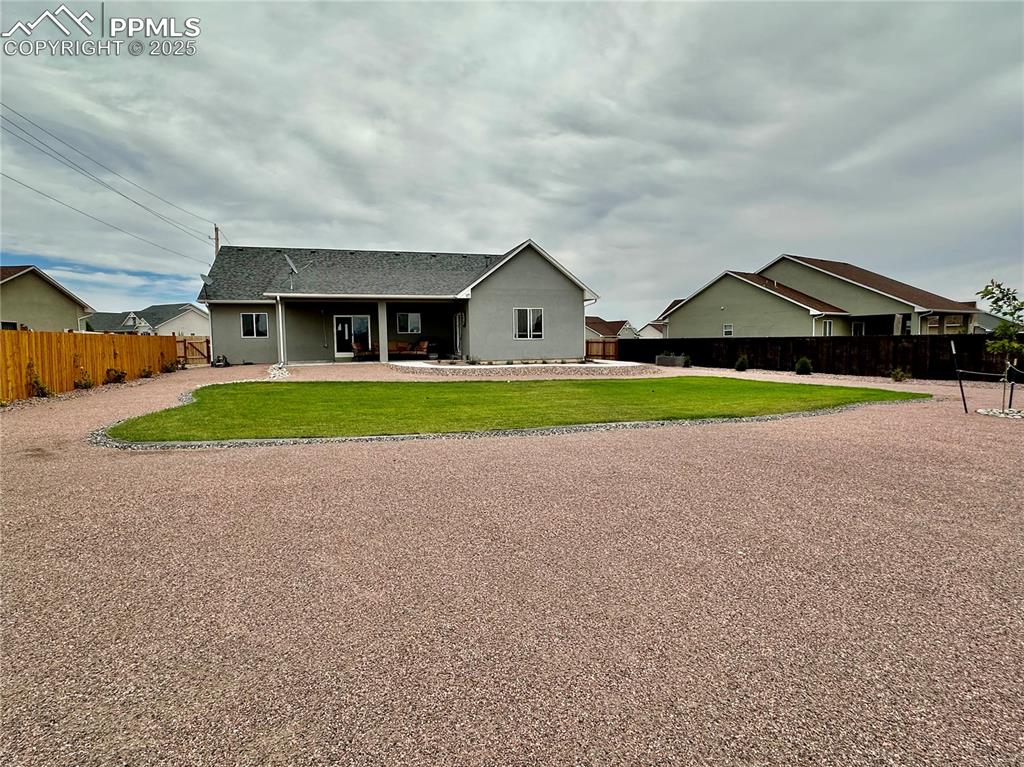 Image 35 of 38: Back of property with a patio area, roof with shingles, and stucco siding