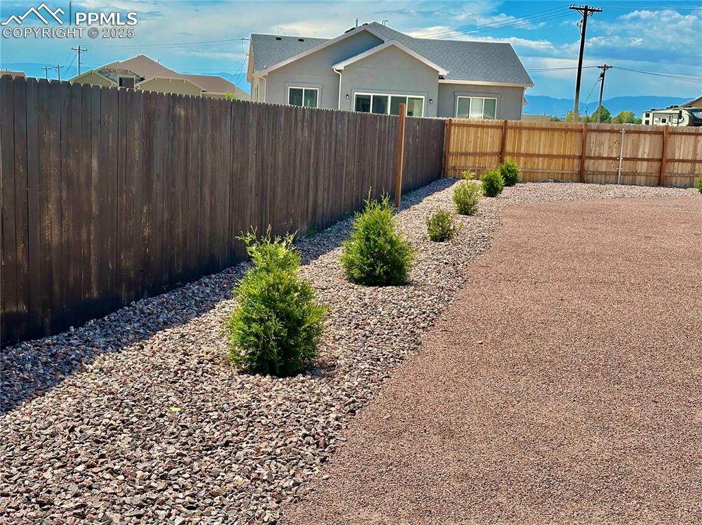 Image 37 of 38: View of fenced backyard