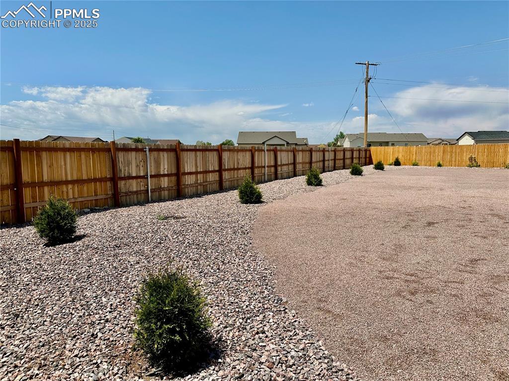 Image 38 of 38: View of fenced backyard