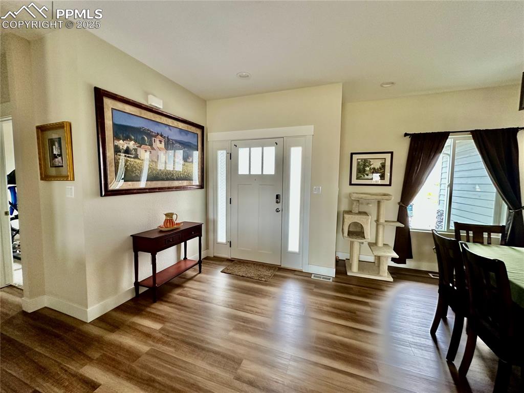 Image 5 of 38: Entryway with wood finished floors, plenty of natural light, and recessed l