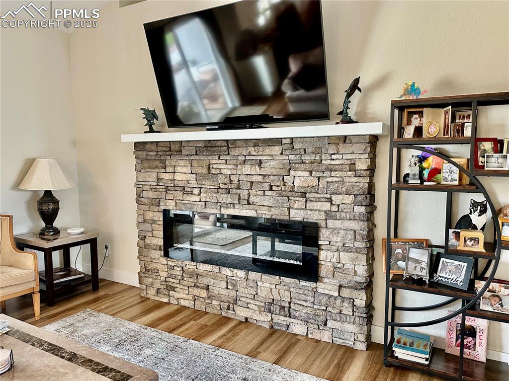 Image 9 of 38: Detailed view of a fireplace and wood finished floors