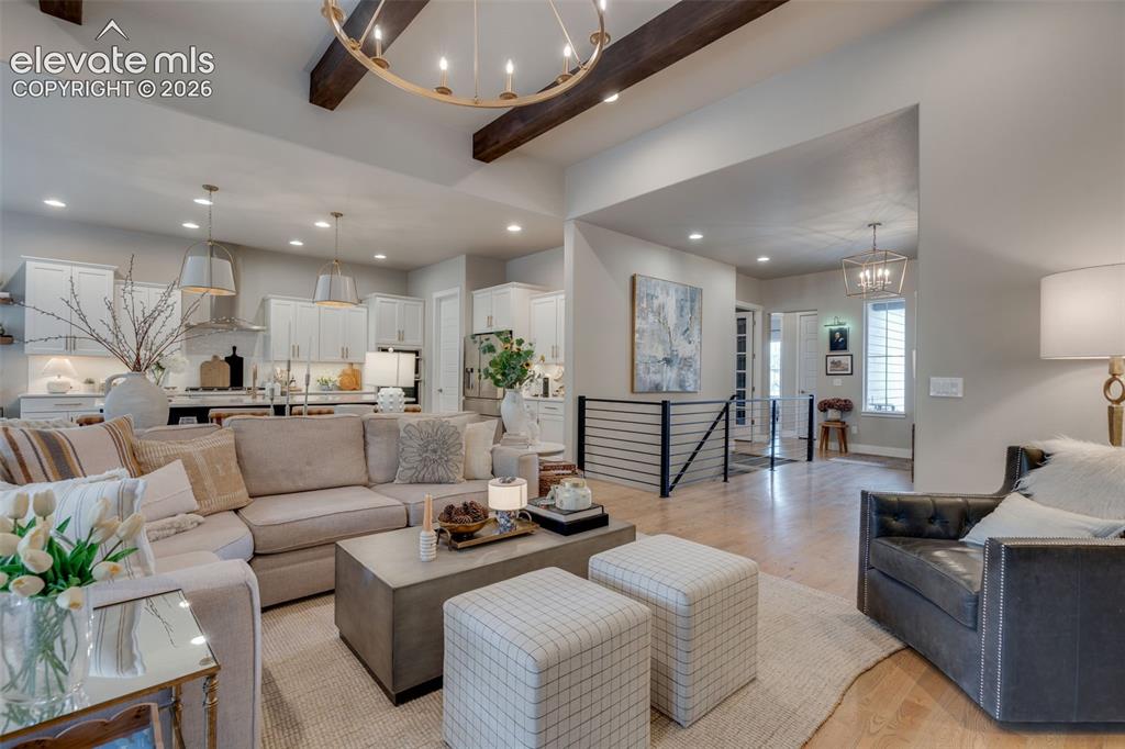 Image 5 of 48: Cozy living room with custom beams