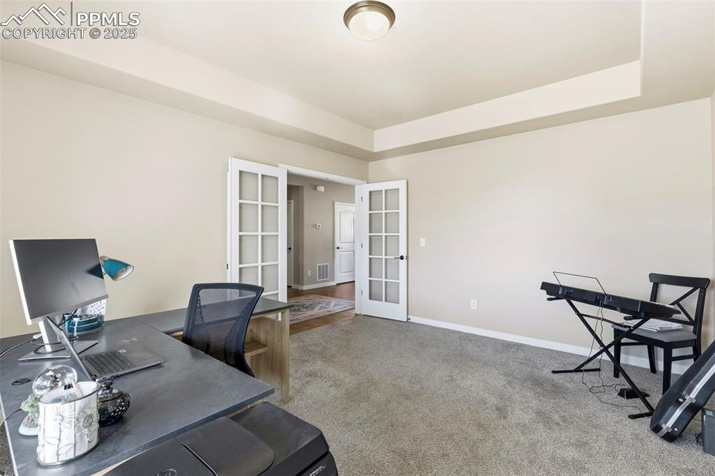 Image 16 of 40: Large Office with Coffered Ceilings could serve multiple uses