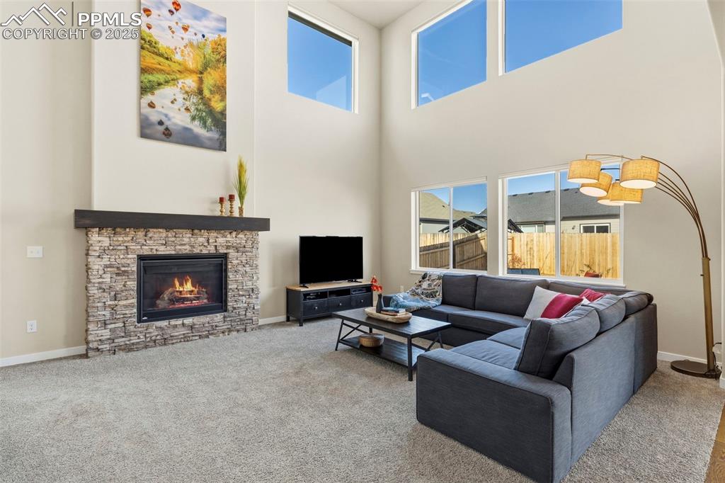 Image 2 of 40: Great Room has Fireplace and Soaring Ceilings!
