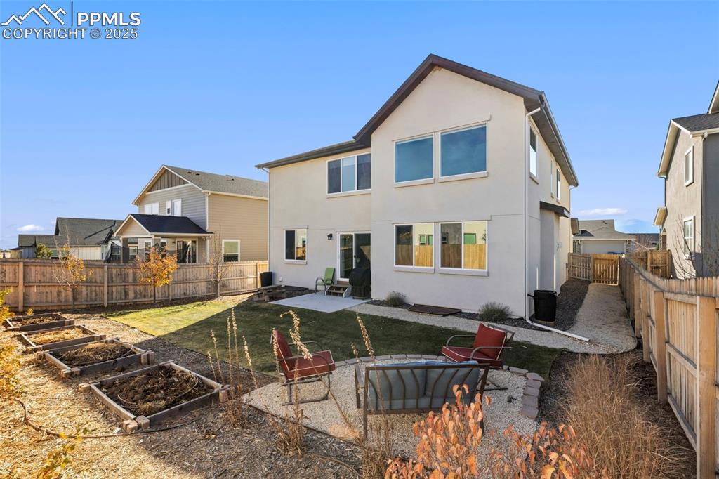 Image 9 of 40: Gardening space and perhaps a firepit area.