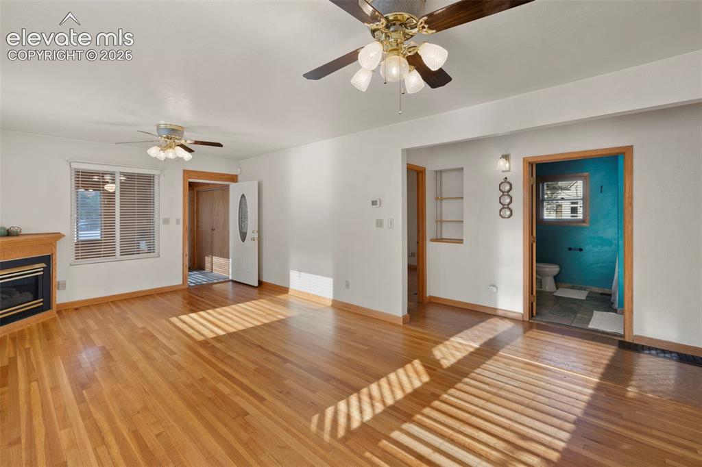 Image 18 of 44: Hardwood flooring throughout, two ceiling fans with integrated lighting, a 