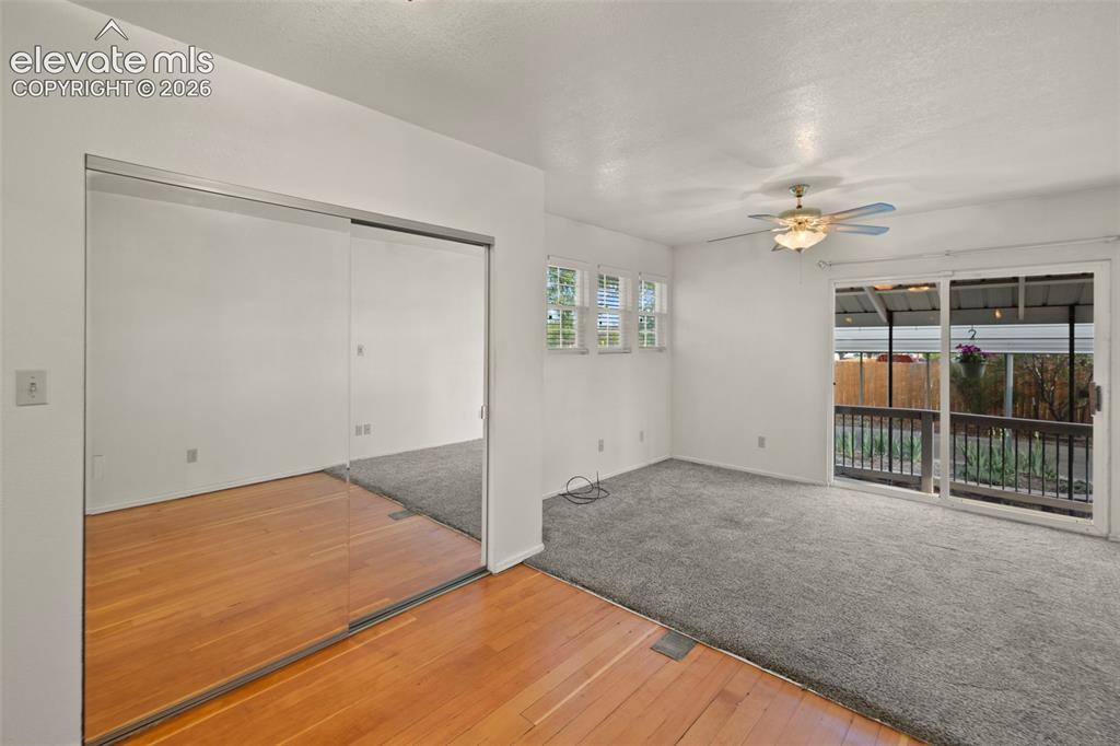 Image 29 of 44: Mirrored sliding closet doors, wood-finish flooring, carpeted area, multi-p