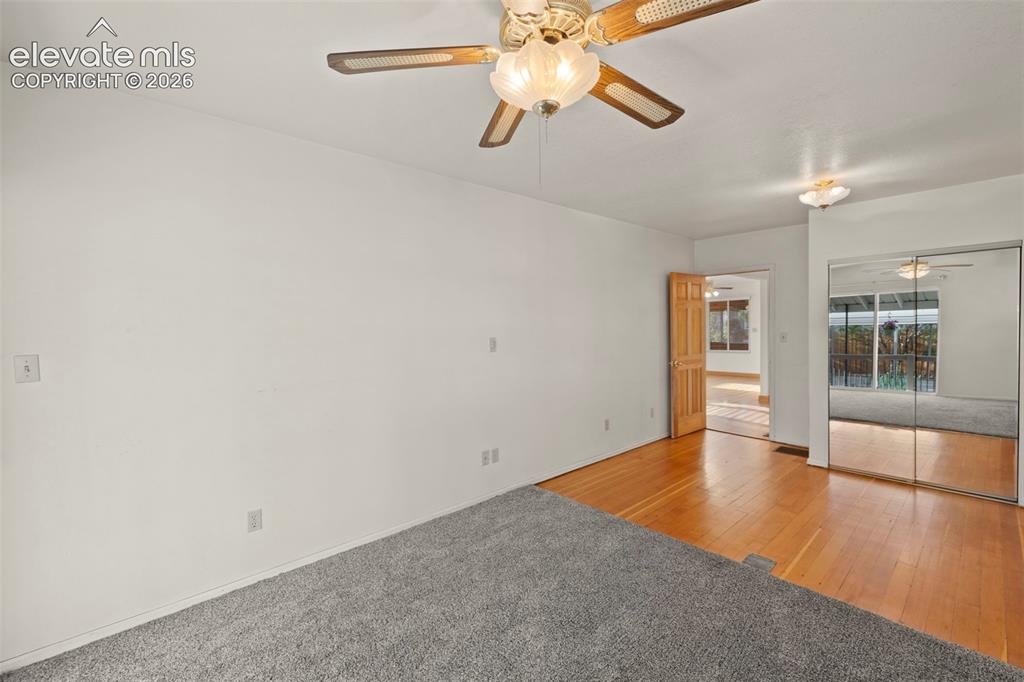 Image 31 of 44: Wall-to-wall carpeting and wood-finish flooring