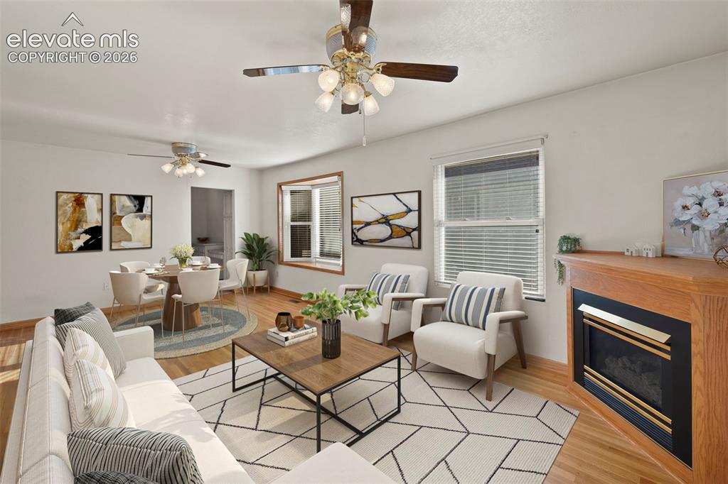 Image 8 of 44: Hardwood-finish flooring throughout, a corner fireplace with a wood surroun