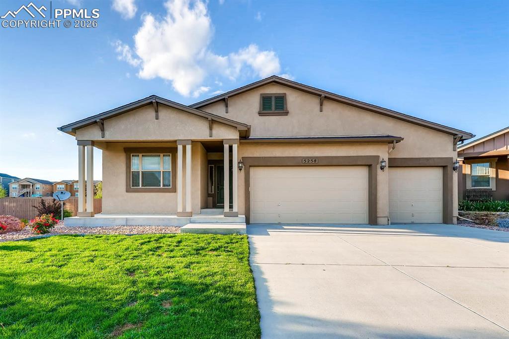 Image 1 of 28: View of front facade with a garage, stucco siding, concrete driveway, and a