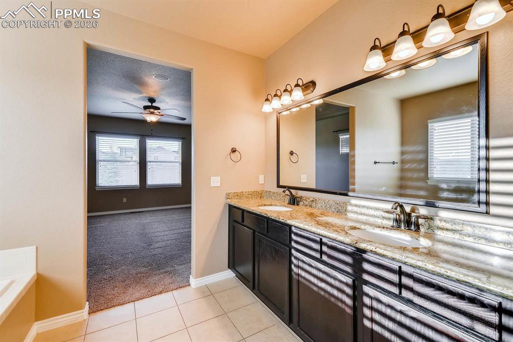Image 16 of 28: Full bath featuring light carpet, double vanity, light tile patterned floor