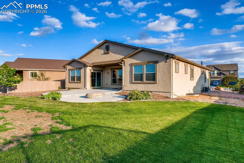 Image 27 of 28: Back of property with a patio and stucco siding