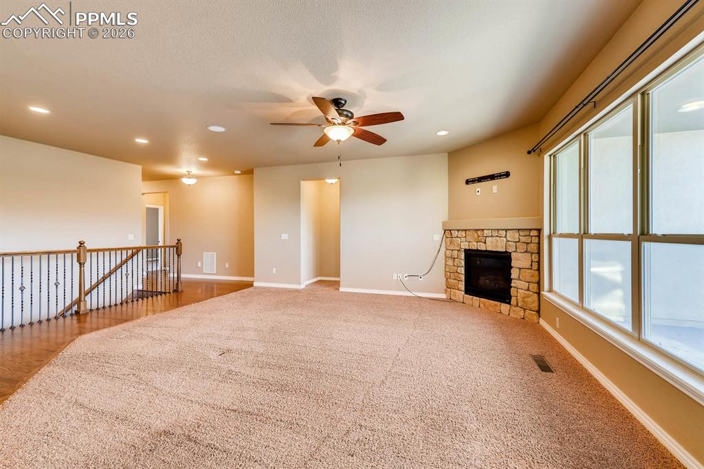 Image 7 of 28: Unfurnished living room featuring a ceiling fan, light colored carpet, rece