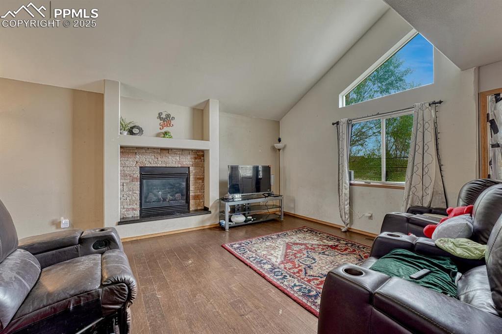 Image 4 of 47: Living room with high ceiling and wood floor