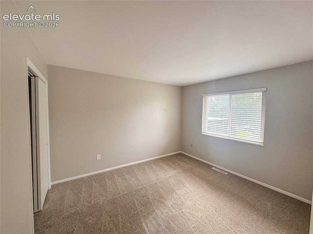 Image 17 of 42: Neutral-toned walls, wall-to-wall carpeting, and a dual-pane window with fi