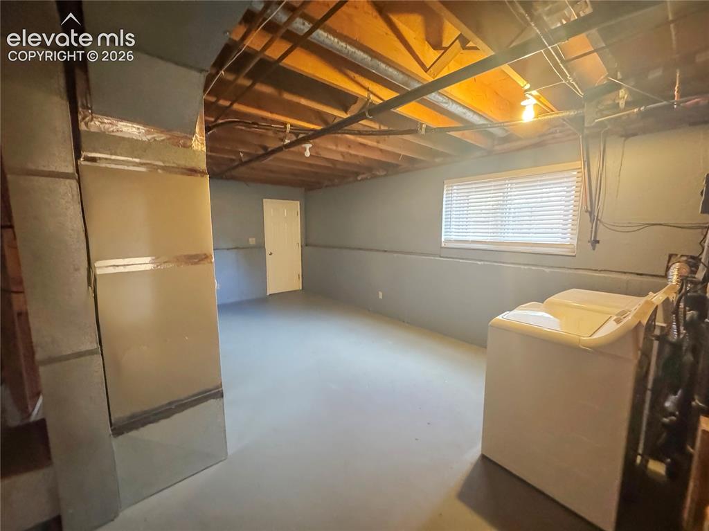 Image 29 of 42: Lower level featuring painted concrete flooring, exposed wood joists, a hor