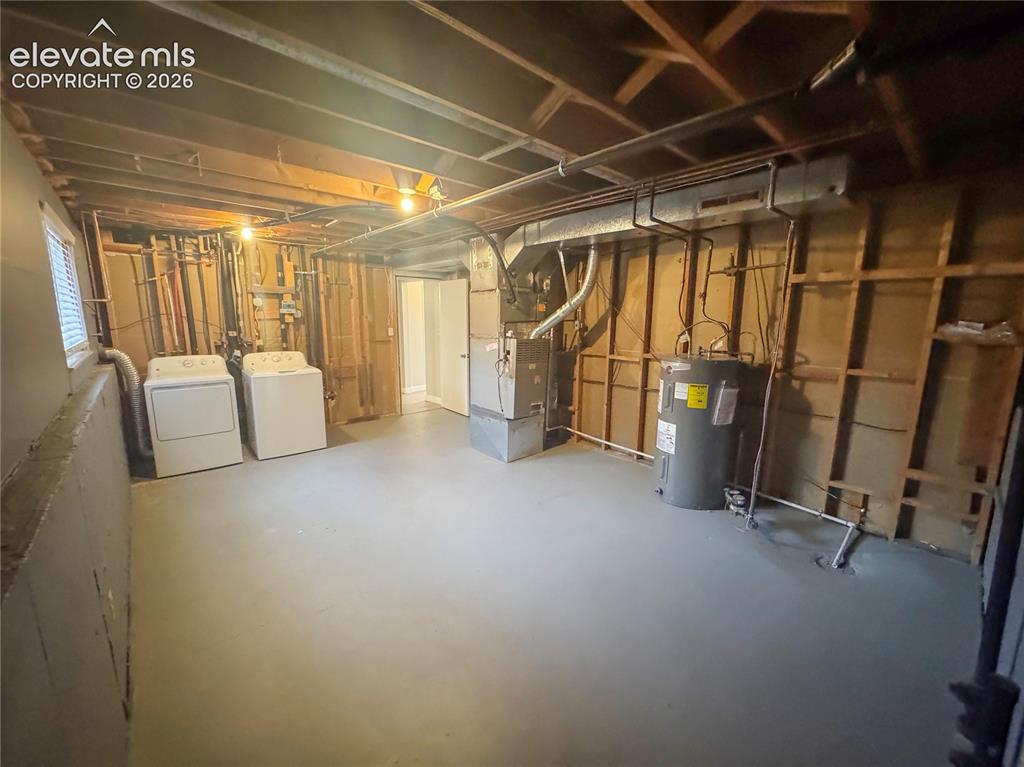 Image 30 of 42: Utility area featuring painted concrete flooring, an exposed wood-joist cei