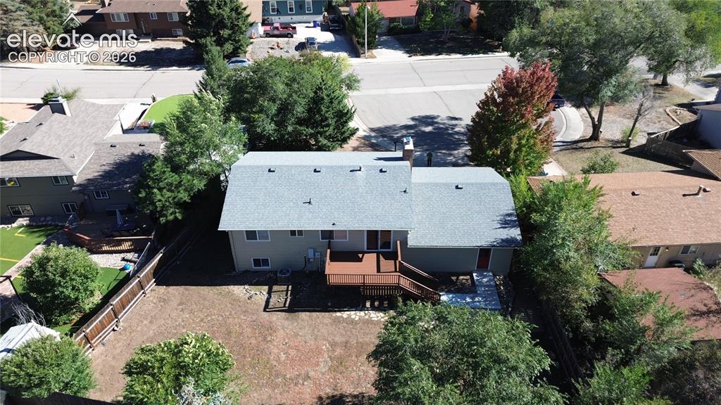 Image 39 of 42: Aerial view featuring a multi-level home with a composition shingle roof, a
