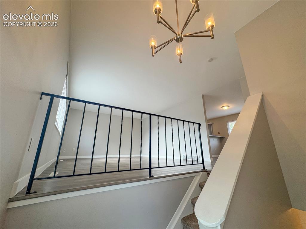 Image 7 of 42: Vaulted ceilings, iron-spindle railing, wood-finish flooring, and a multi-a